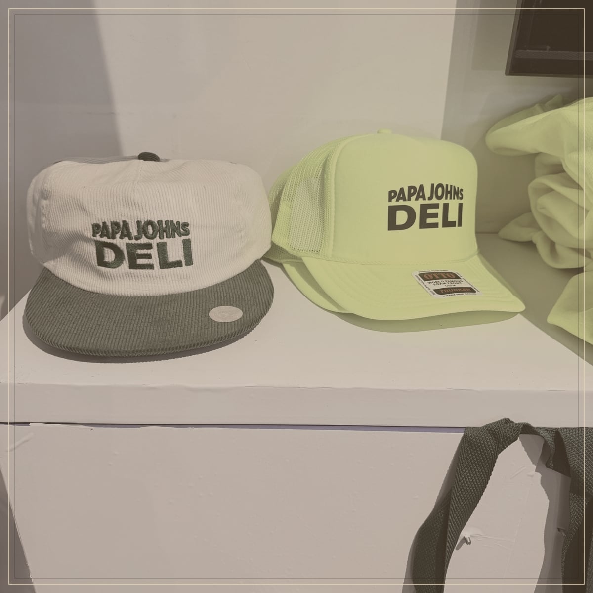 Embroidered caps styled on a shelf for a resort boutique program