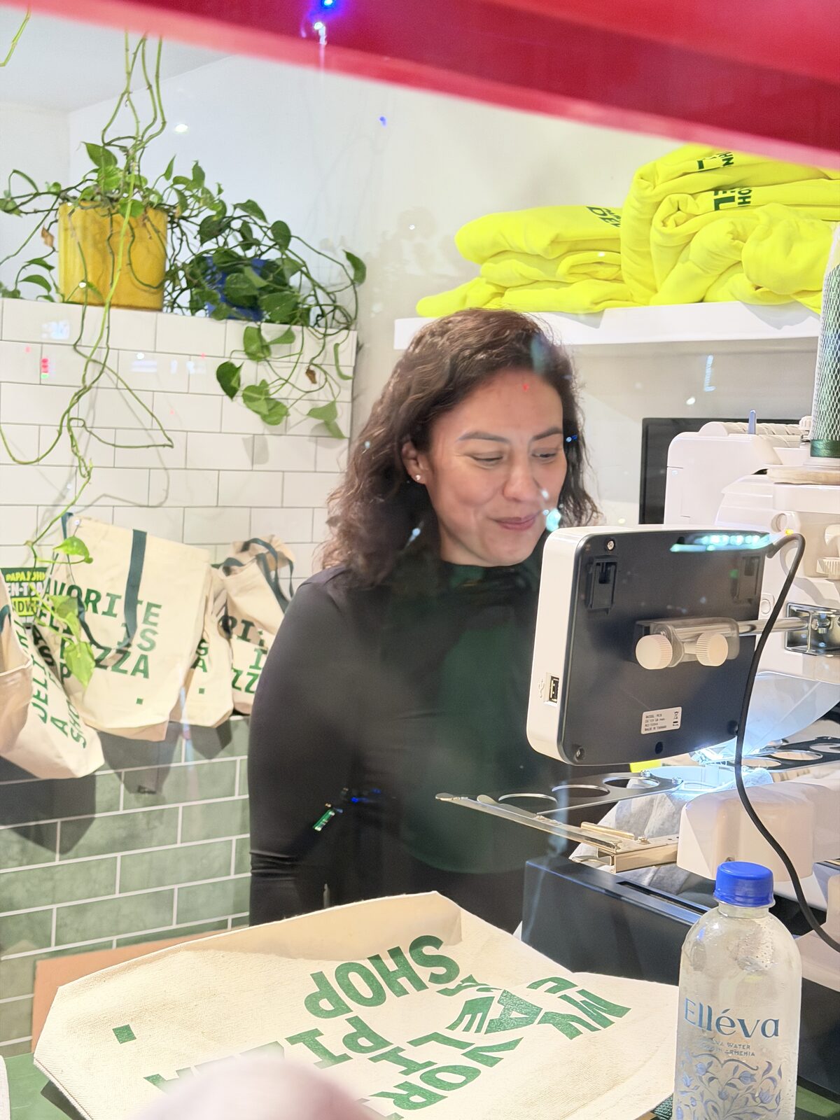 Live embroidery station personalizing totes inside a retail shop