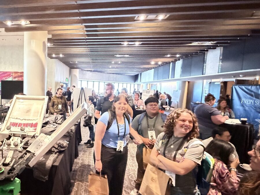Summit attendees carrying gift bags after visiting a corporate gifting suite
