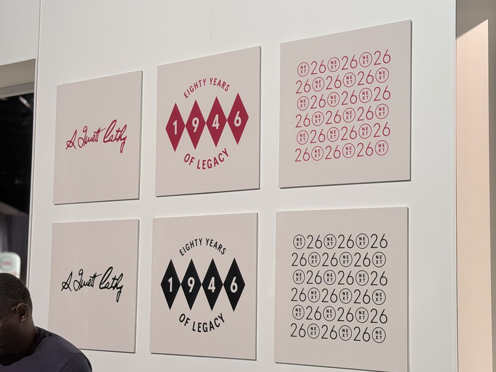Anniversary letterform artwork proofs displayed on a retail activation wall